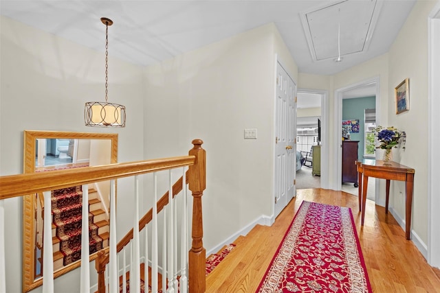 5005 John Hancock Ct Unit 100, New Windsor, NY 12553 - hallway featuring attic access, light wood-type flooring, an upstairs landing, and baseboards