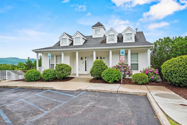 5005 John Hancock Ct Unit 100, New Windsor, NY 12553 - new england style home featuring a porch and uncovered parking