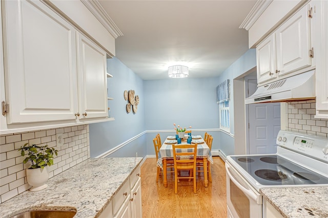 199 Millard Ave Unit 199, West Babylon, NY 11704 - kitchen featuring white electric stove, under cabinet range hood, light wood-type flooring, decorative backsplash, and white cabinetry