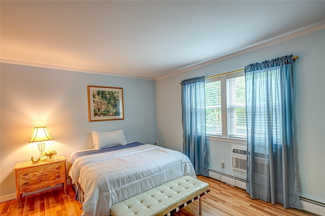 199 Millard Ave Unit 199, West Babylon, NY 11704 - bedroom featuring a baseboard heating unit, crown molding, baseboard heating, and light wood-type flooring