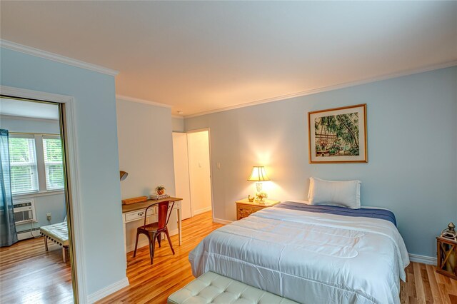 199 Millard Ave Unit 199, West Babylon, NY 11704 - bedroom featuring light wood-style floors, crown molding, a baseboard heating unit, and baseboards