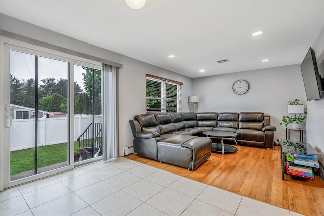 130 W 7th St, Deer Park, NY 11729 - living room featuring light tile patterned flooring, baseboard heating, and recessed lighting