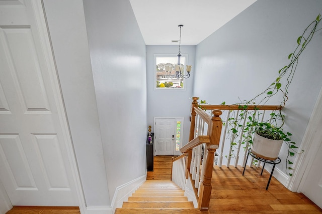 130 W 7th St, Deer Park, NY 11729 - staircase featuring wood finished floors and a chandelier