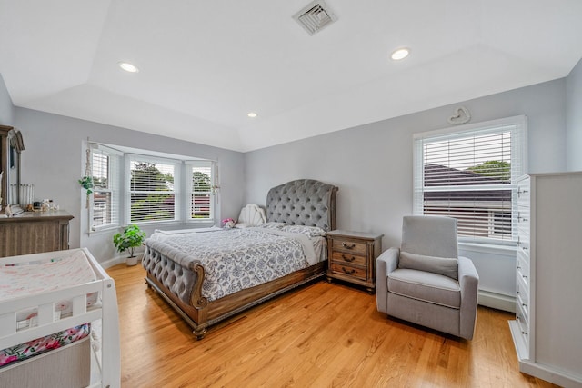 130 W 7th St, Deer Park, NY 11729 - bedroom with a tray ceiling, light wood-type flooring, a baseboard heating unit, recessed lighting, and baseboards