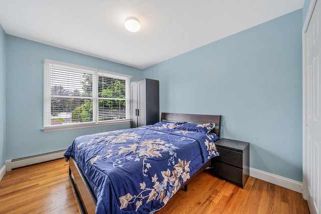130 W 7th St, Deer Park, NY 11729 - bedroom with a baseboard radiator, wood finished floors, and baseboards
