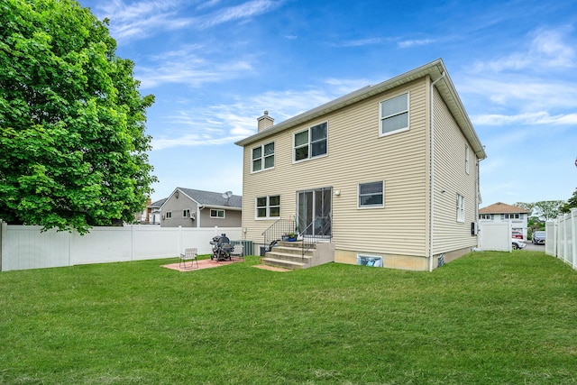 130 W 7th St, Deer Park, NY 11729 - back of property featuring a chimney, entry steps, a patio area, and central AC