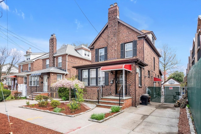 200-12 36th Ave, Bayside, NY 11361 - view of front of house featuring a gate, brick siding, and a chimney