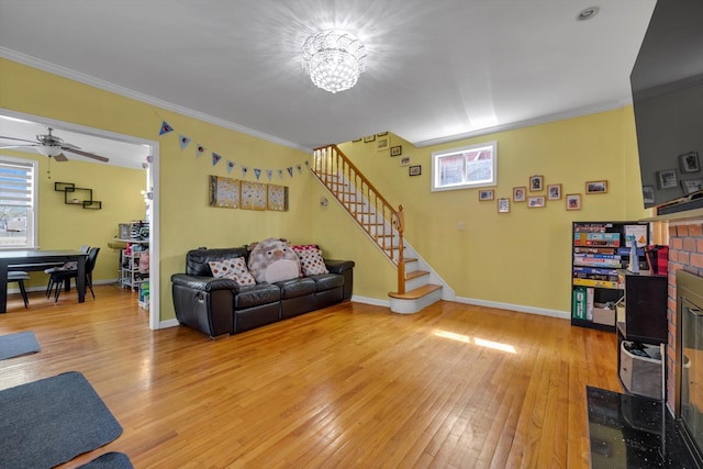200-12 36th Ave, Bayside, NY 11361 - living room with stairs, light wood-style floors, crown molding, baseboards, and a ceiling fan