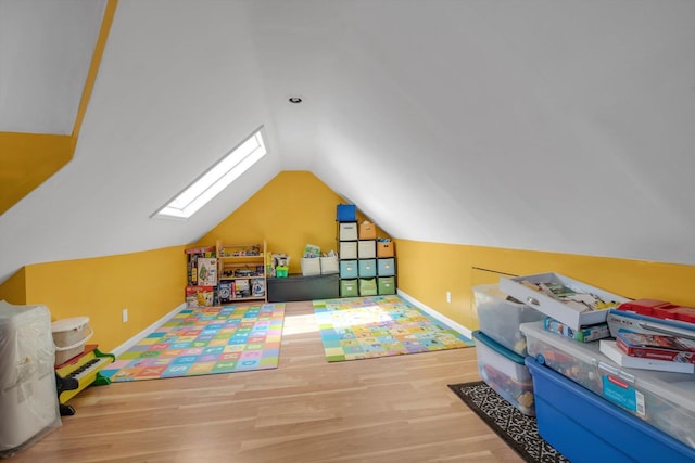 200-12 36th Ave, Bayside, NY 11361 - recreation room featuring a skylight, wood finished floors, and lofted ceiling