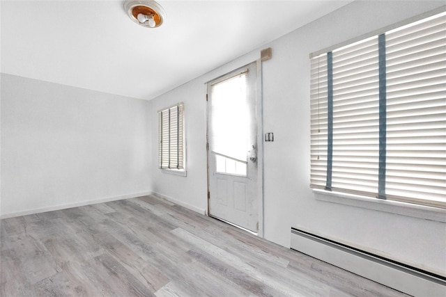 3680 Naomi St, Seaford, NY 11783 - foyer with a baseboard radiator and wood finished floors