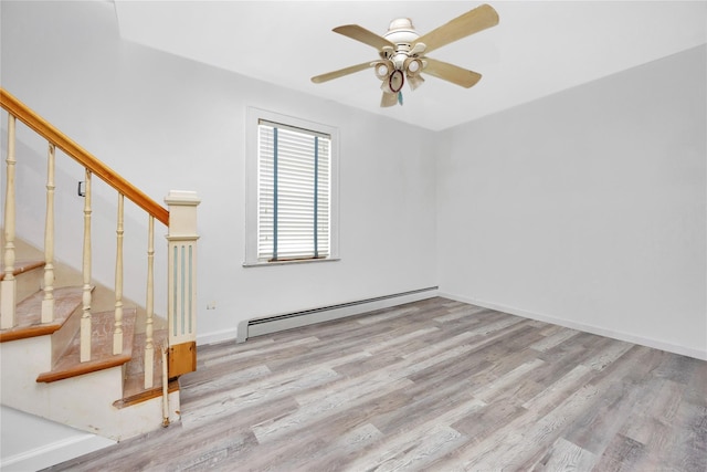 3680 Naomi St, Seaford, NY 11783 - spare room with a baseboard heating unit, wood finished floors, ceiling fan, stairs, and baseboards