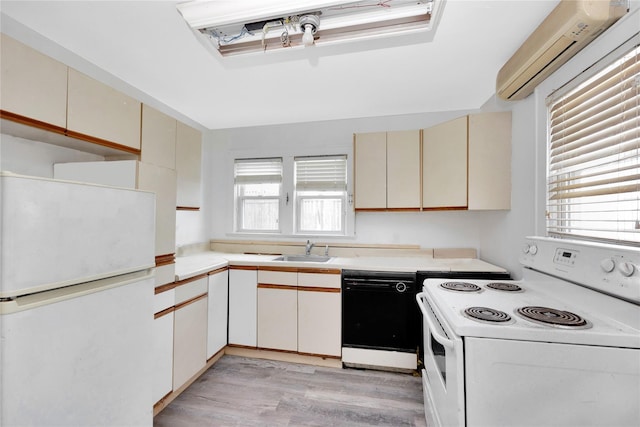 3680 Naomi St, Seaford, NY 11783 - kitchen featuring white appliances, cream cabinets, a wall mounted air conditioner, light countertops, and light wood-type flooring