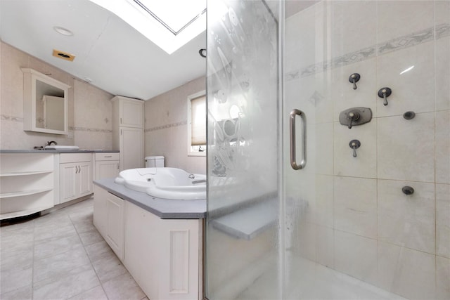3680 Naomi St, Seaford, NY 11783 - bathroom with a skylight, vanity, a stall shower, and tile patterned flooring