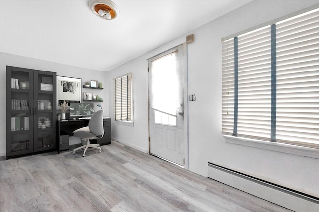 3680 Naomi St, Seaford, NY 11783 - office space with a baseboard heating unit and wood finished floors