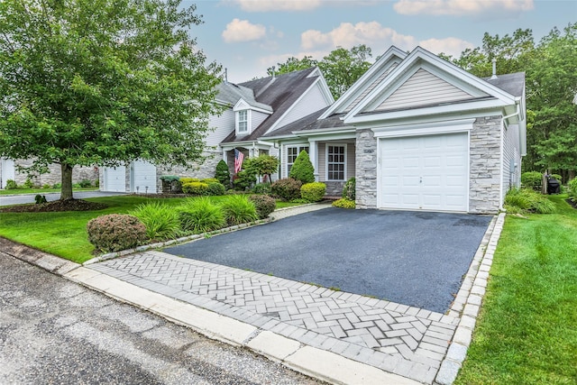 75 Madison Cir, Middle Island, NY 11953 - view of front of home with stone siding, an attached garage, asphalt driveway, and a front lawn