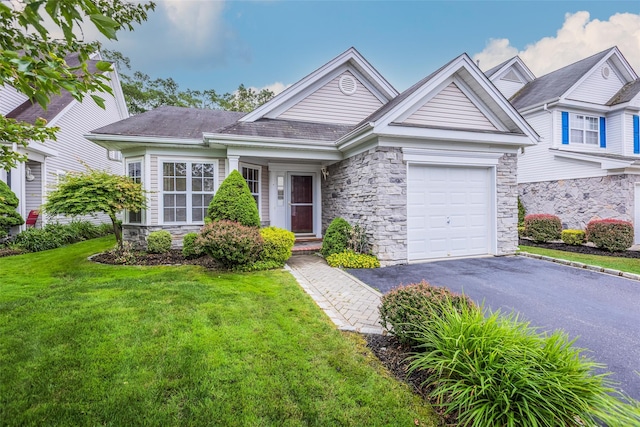 75 Madison Cir, Middle Island, NY 11953 - view of front of property with stone siding, a front yard, asphalt driveway, and a garage