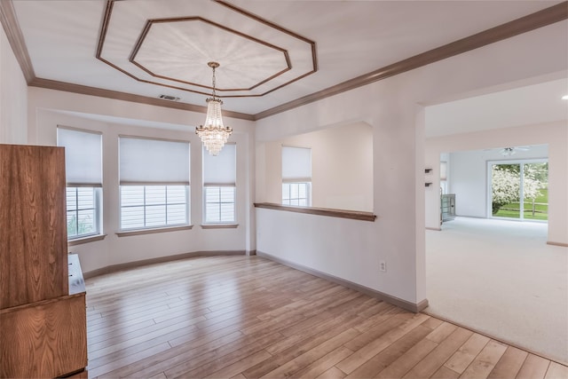 75 Madison Cir, Middle Island, NY 11953 - spare room with ornamental molding, a chandelier, healthy amount of natural light, and wood finished floors