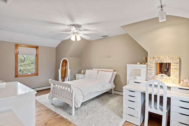 13 Evans Ave, Albertson, NY 11507 - bedroom featuring a baseboard heating unit, light wood-style flooring, vaulted ceiling, an office area, and ceiling fan