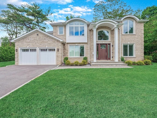 15 Grenfell Dr, Great Neck, NY 11020 - view of front facade featuring driveway, a garage, a front yard, and brick siding