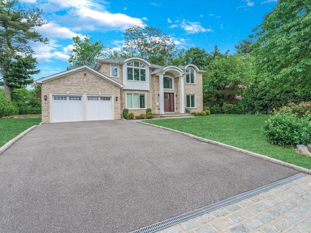 15 Grenfell Dr, Great Neck, NY 11020 - view of front of property featuring an attached garage, asphalt driveway, and a front lawn