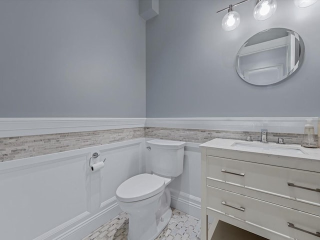 15 Grenfell Dr, Great Neck, NY 11020 - bathroom with toilet, vanity, wainscoting, and tile patterned flooring