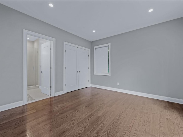 15 Grenfell Dr, Great Neck, NY 11020 - unfurnished bedroom with wood finished floors, baseboards, recessed lighting, a closet, and ensuite bath