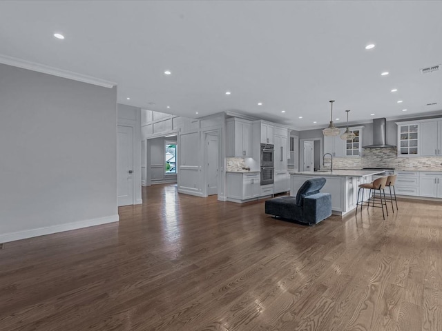 15 Grenfell Dr, Great Neck, NY 11020 - living area featuring recessed lighting, crown molding, dark wood finished floors, and baseboards