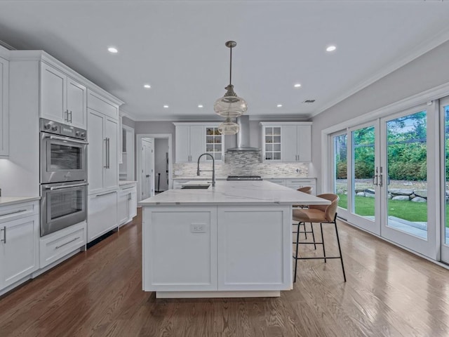15 Grenfell Dr, Great Neck, NY 11020 - kitchen featuring wall chimney range hood, a sink, stainless steel double oven, ornamental molding, and tasteful backsplash