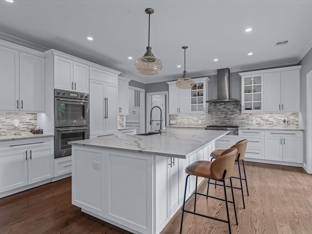 15 Grenfell Dr, Great Neck, NY 11020 - kitchen featuring wall chimney exhaust hood, a sink, double oven, decorative backsplash, and white cabinetry
