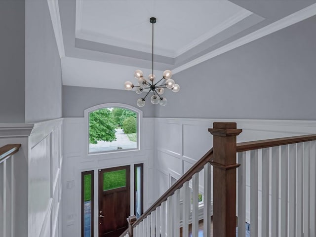 15 Grenfell Dr, Great Neck, NY 11020 - entrance foyer with a chandelier, a tray ceiling, a decorative wall, and wainscoting
