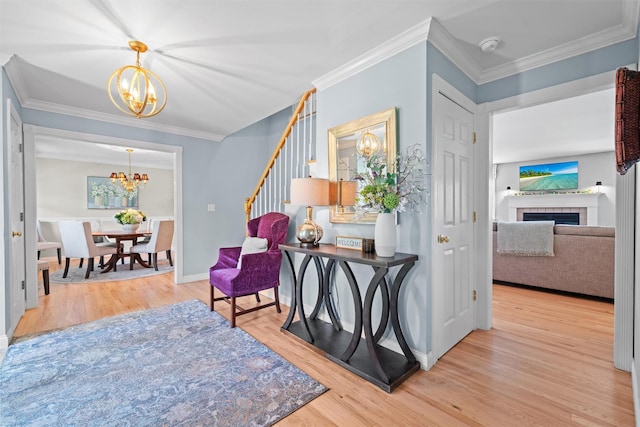 17 Jackson Ln, Campbell Hall, NY 10916 - entrance foyer with a chandelier, wood finished floors, ornamental molding, stairway, and a fireplace