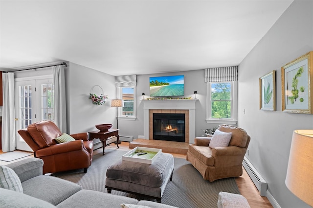 17 Jackson Ln, Campbell Hall, NY 10916 - living room with a baseboard heating unit, plenty of natural light, a tiled fireplace, and wood finished floors