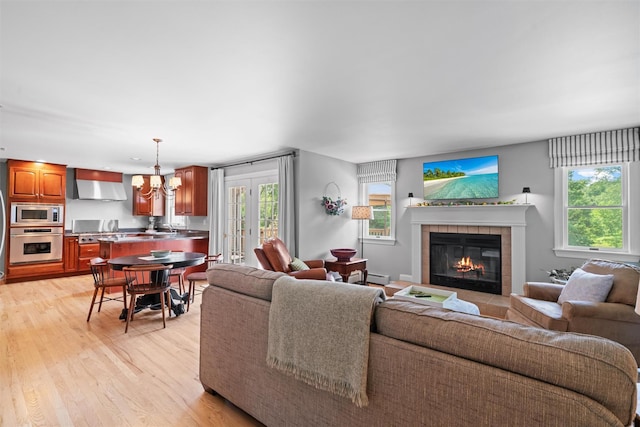17 Jackson Ln, Campbell Hall, NY 10916 - living area with a tiled fireplace, light wood-style flooring, and a chandelier