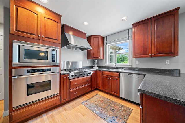 17 Jackson Ln, Campbell Hall, NY 10916 - kitchen featuring stainless steel appliances, wall chimney range hood, dark countertops, light wood-style floors, and recessed lighting