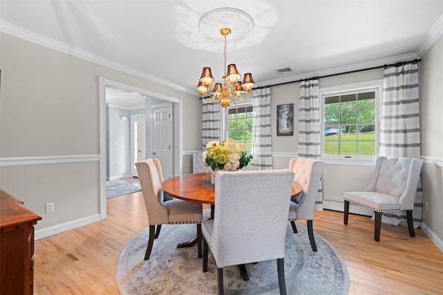 17 Jackson Ln, Campbell Hall, NY 10916 - dining area with ornamental molding, a chandelier, and light wood-style flooring