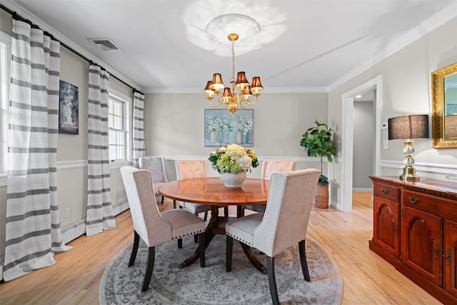 17 Jackson Ln, Campbell Hall, NY 10916 - dining space with a chandelier, light wood-type flooring, and crown molding