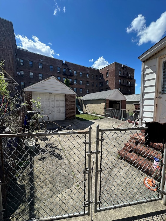 5224 66th St, Maspeth, NY 11378 - view of parking / parking lot featuring a gate and a garage