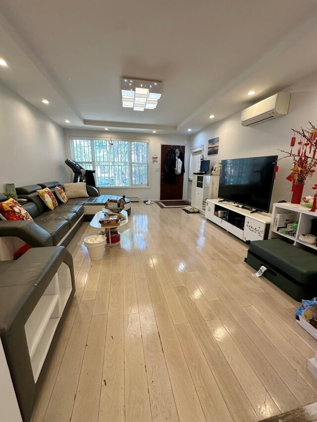 5224 66th St, Maspeth, NY 11378 - living area with a raised ceiling, a wall mounted air conditioner, light wood finished floors, and recessed lighting