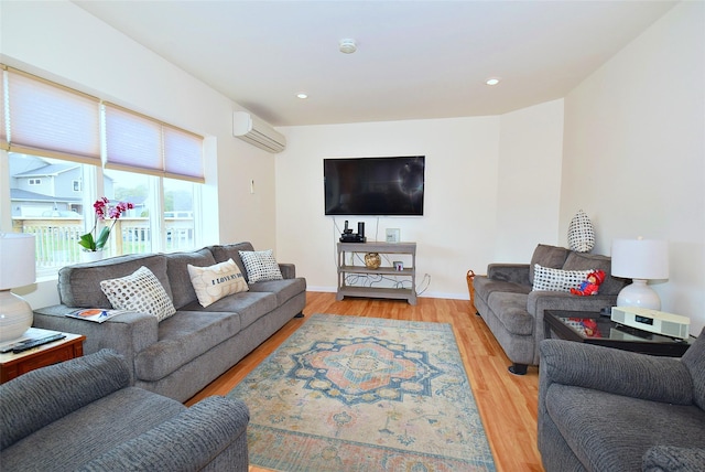 32 Shore Dr, Mastic Beach, NY 11951 - living room featuring wood finished floors, a wall mounted air conditioner, and baseboards