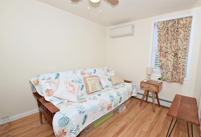 32 Shore Dr, Mastic Beach, NY 11951 - sitting room featuring a wall mounted air conditioner, wood finished floors, a baseboard heating unit, ceiling fan, and baseboards