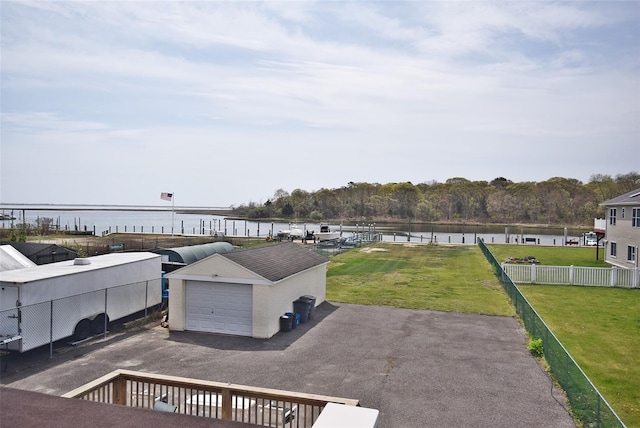 32 Shore Dr, Mastic Beach, NY 11951 - view of patio featuring a water view, an outdoor structure, a garage, and asphalt driveway
