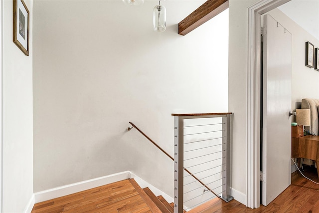 110-25 64th Rd Unit 10, Forest Hills, NY 11375 - stairway featuring wood finished floors, beam ceiling, and baseboards