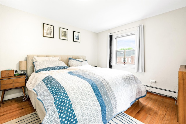 110-25 64th Rd Unit 10, Forest Hills, NY 11375 - bedroom with a baseboard radiator and hardwood / wood-style floors