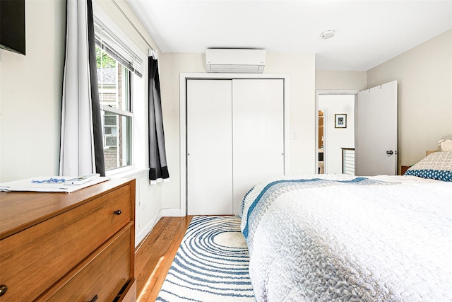 110-25 64th Rd Unit 10, Forest Hills, NY 11375 - bedroom featuring a wall unit AC, light wood-type flooring, and a closet