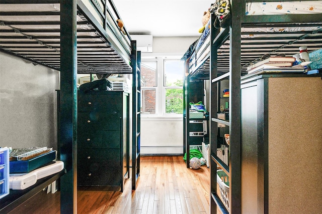 110-25 64th Rd Unit 10, Forest Hills, NY 11375 - bedroom with wood-type flooring and a baseboard heating unit