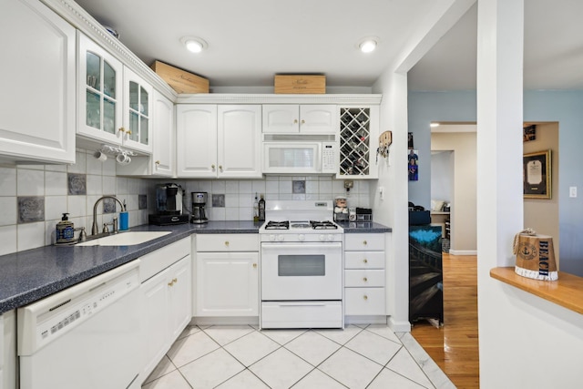 74 Bon Aire Cir Unit Q10, Suffern, NY 10901 - kitchen with white appliances, a sink, glass insert cabinets, and white cabinets