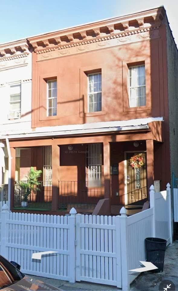 2311 Cortelyou Rd, Brooklyn, NY 11226 - view of front of house featuring a porch, a fenced front yard, and a gate