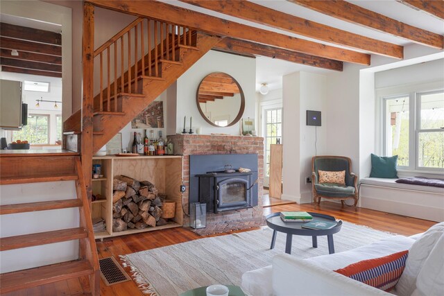 57 Dellenbaugh Rd, Cragsmoor, NY 12566 - living room featuring stairway, beam ceiling, wood finished floors, and plenty of natural light