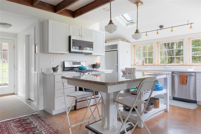 57 Dellenbaugh Rd, Cragsmoor, NY 12566 - kitchen featuring stainless steel appliances, plenty of natural light, a skylight, beam ceiling, and concrete flooring