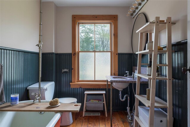 57 Dellenbaugh Rd, Cragsmoor, NY 12566 - bathroom with a wainscoted wall and hardwood / wood-style flooring
